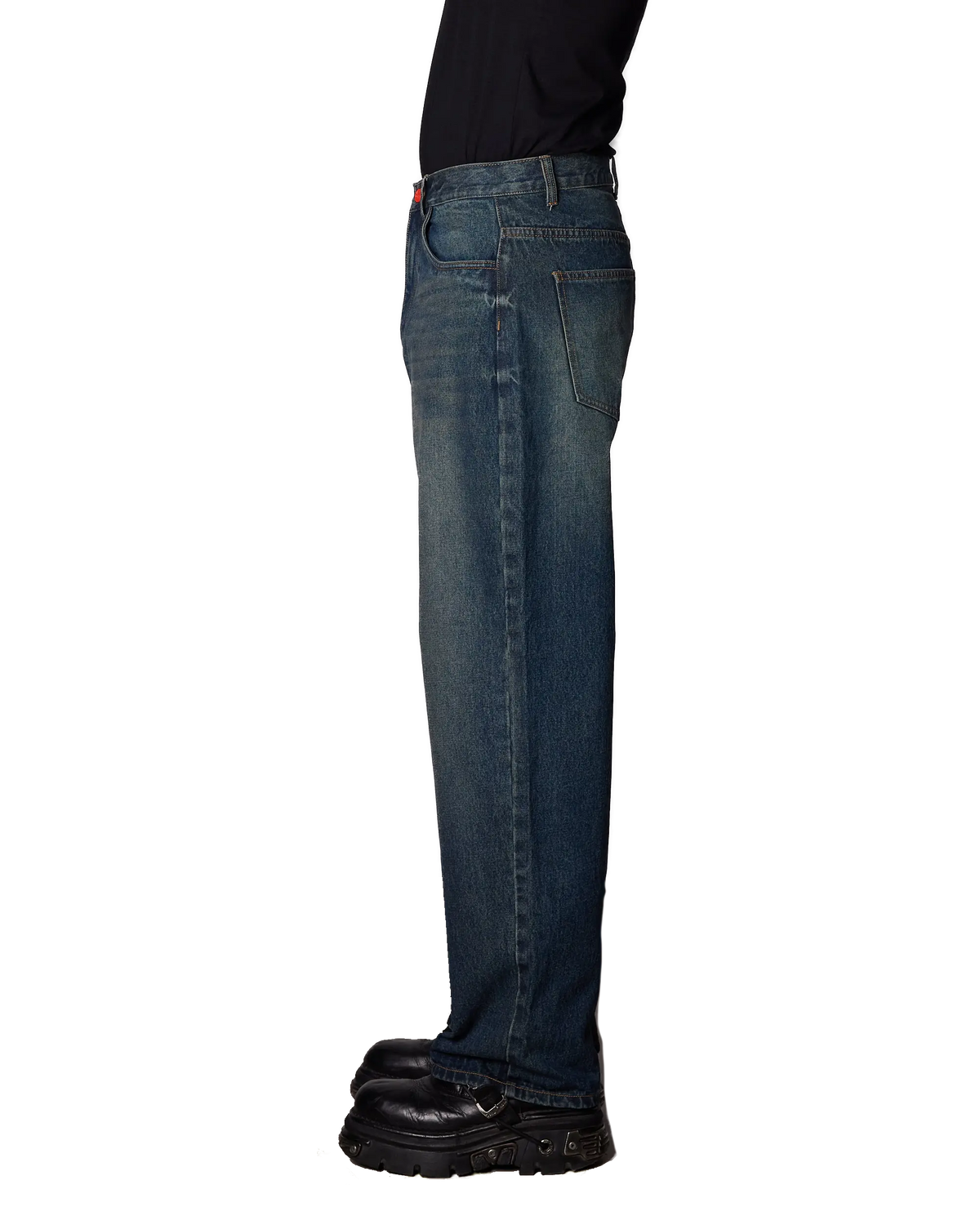 Side profile of a person wearing BeWider Super Loose Jeans in Blue Star wash with a black shirt and black leather shoes, shown against a plain white background.