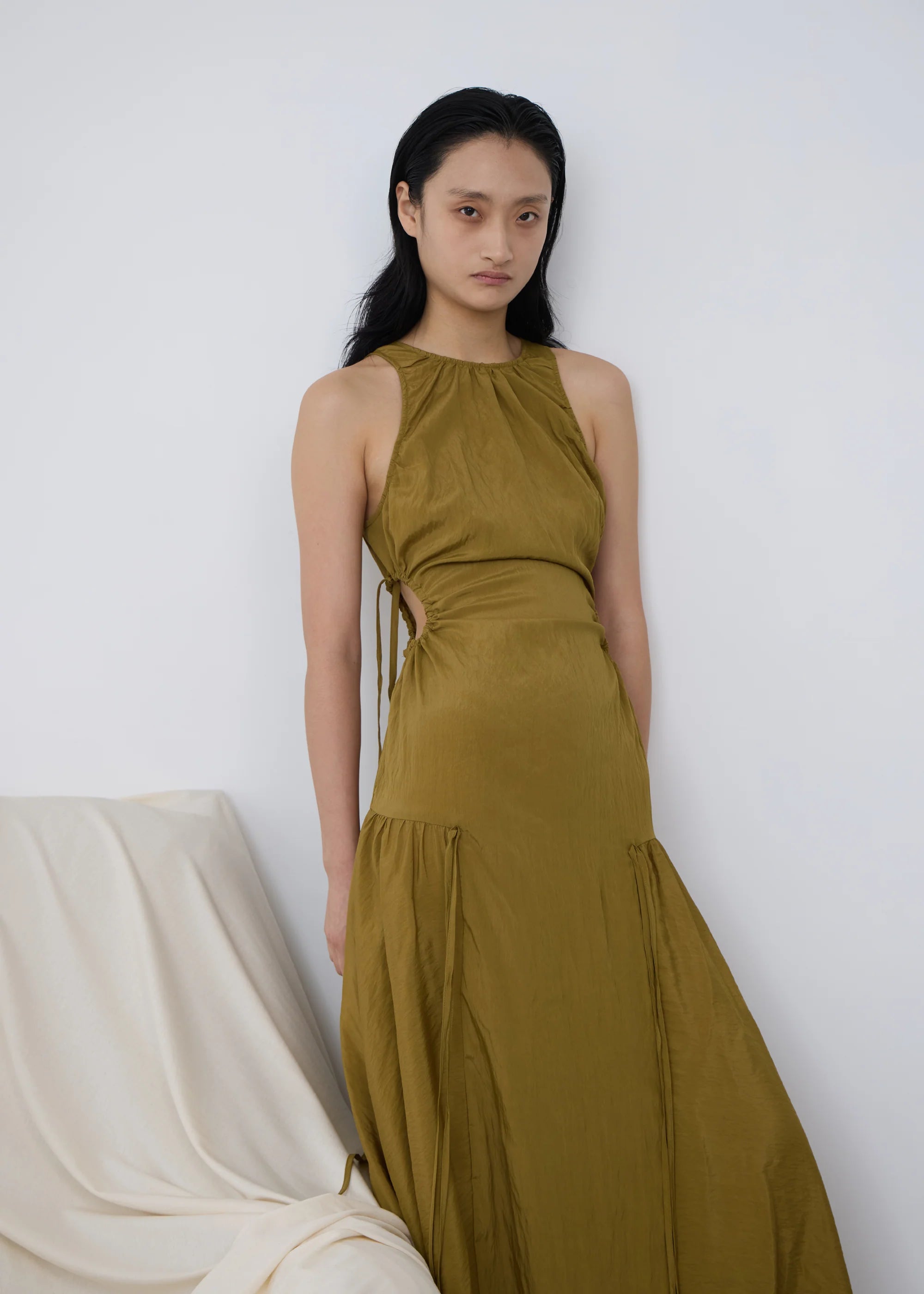 Woman wearing a kelp orbit PV dress against a white background