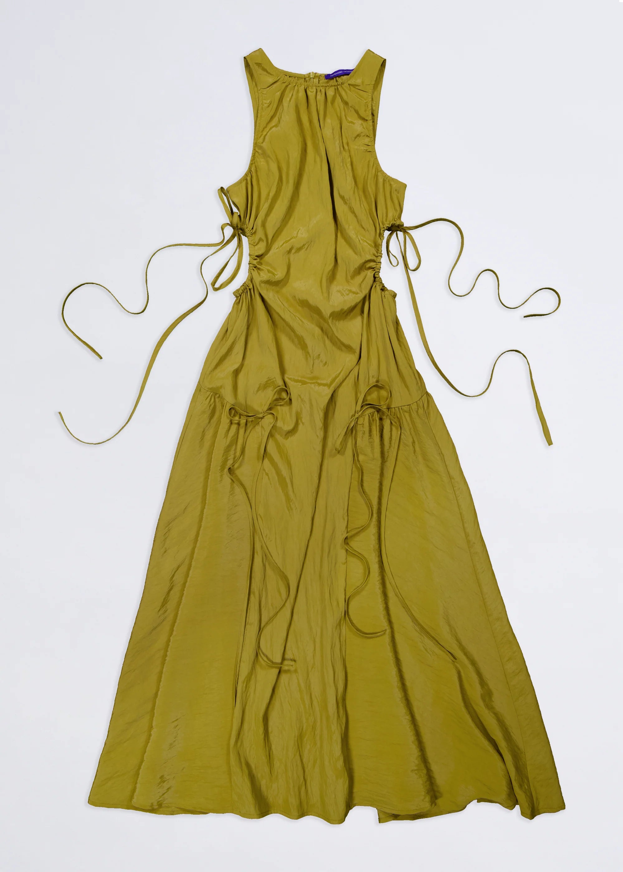 flatlay of kelp green orbit permanent vacation dress with ribbon details on a white background