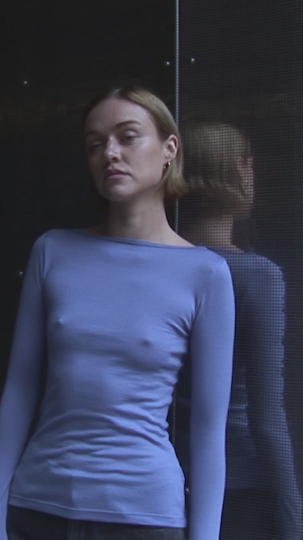 Video of woman wearing long sleeve permanent vacation connection top in blue rose